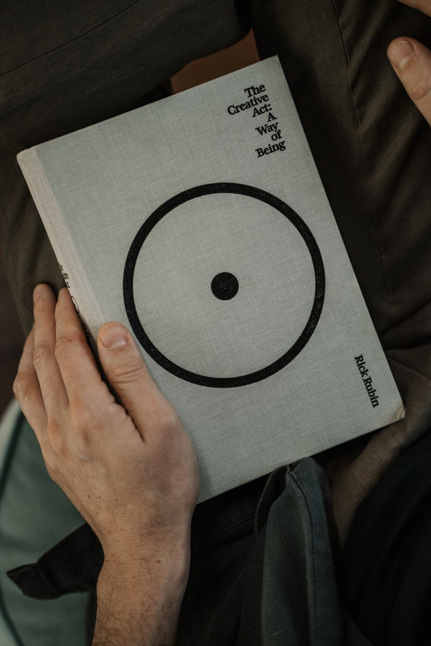 Hands holding a book marked with a circle